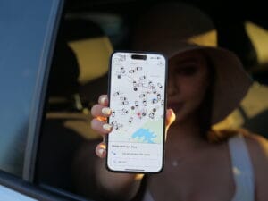 Patoko App being held by someone sitting in a car